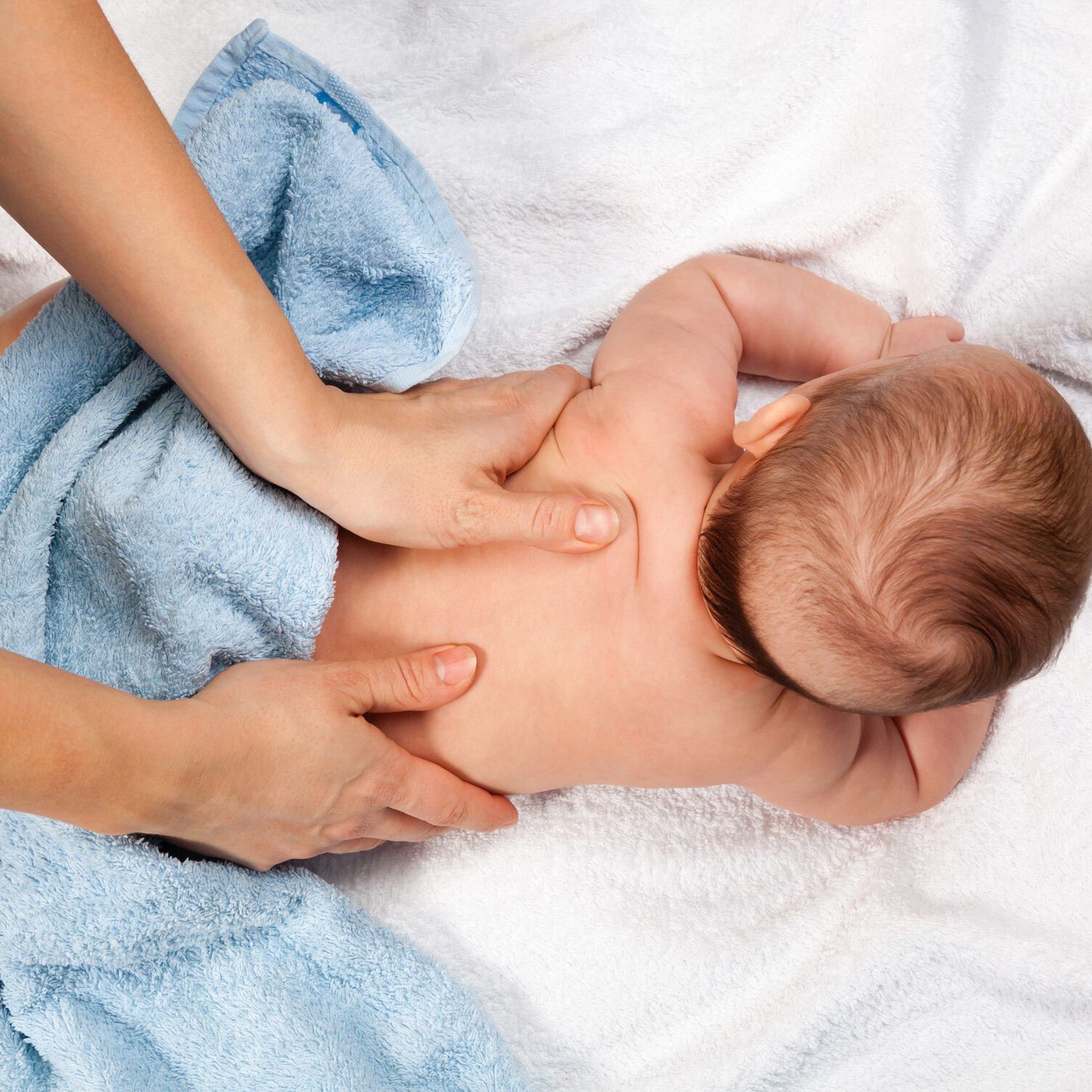 Masseuse massaging 5 months infant
